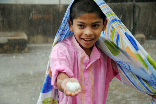 A boy shows hails during a hail-storm in Hyderabad on Friday evening. PTI Photo