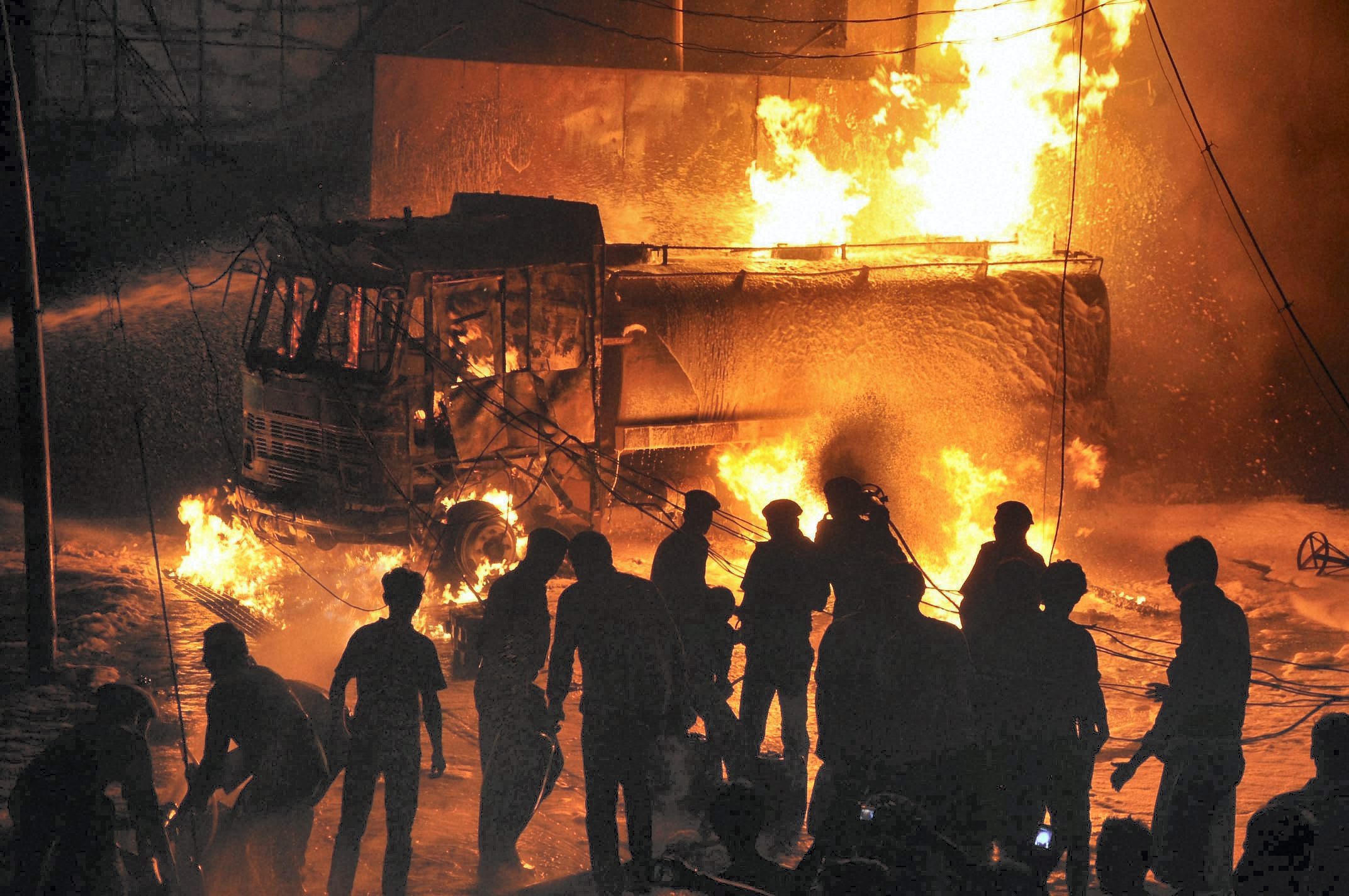 Fire fighters trying to extinguish fire at a petrol pump in Ranchi on Monday night. No casulaties were reported in the fire. PTI