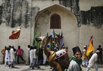 Indian Muslim Sufi devotees who are on a pilgrimage to Ajmer Sharif, a revered Muslim shrine in India's western state of Rajasthan, walk in New   Delhi, India, Tuesday, May 8, 2012. Thousands of Sufi devotees from different parts of the country annua...