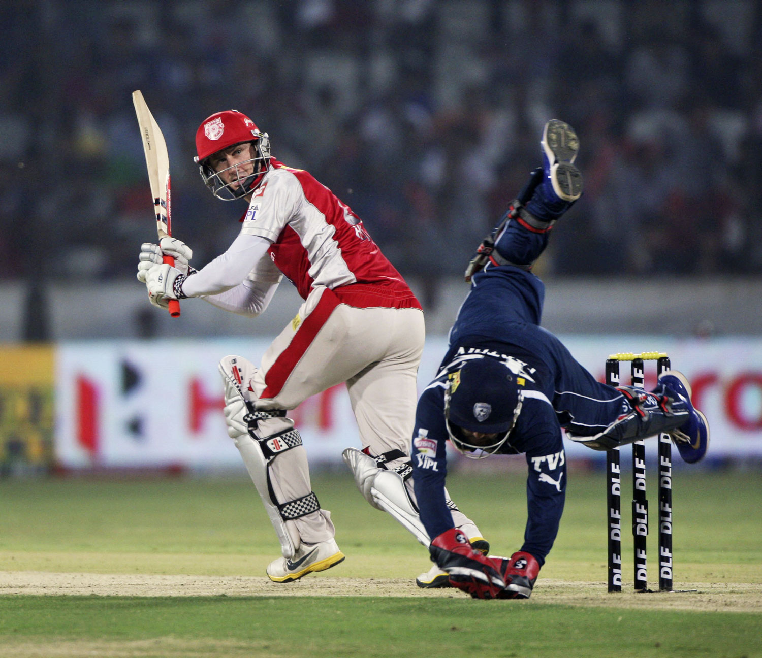 Deccan Chargers wicket keeper Parthiv Patel, foreground, dives as he tries to stop the ball as Kings XI Punjab's David John Hussey plays a shot during their Indian Premier League (IPL) cricket match in Hyderabad on Tuesday. AP