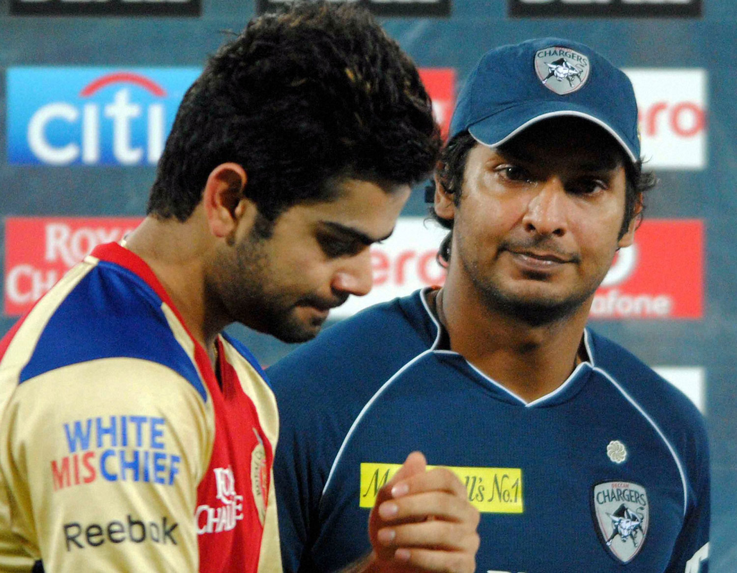 Royal Challengers Bangalore's captain Virat Kohli looks dejected as he stands with Deccan Chargers captain K Sangakkara during award ceremony of an IPL 5 match which was won by the Chargers in Hyderabad on Sunday. PTI