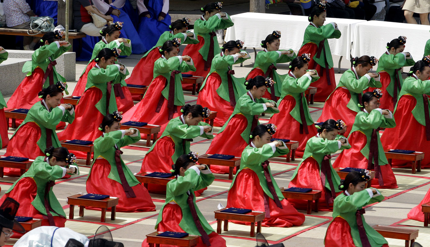 Girls wearing traditional dresses, bow during the 40th Coming of Age Day  ceremony, known traditionally in South Korea as Gwan-Rye, in Seoul, South Korea,  Monday, May 21, 2012. The ceremony is held to recognize boys and girls at the  age of 20, who ...