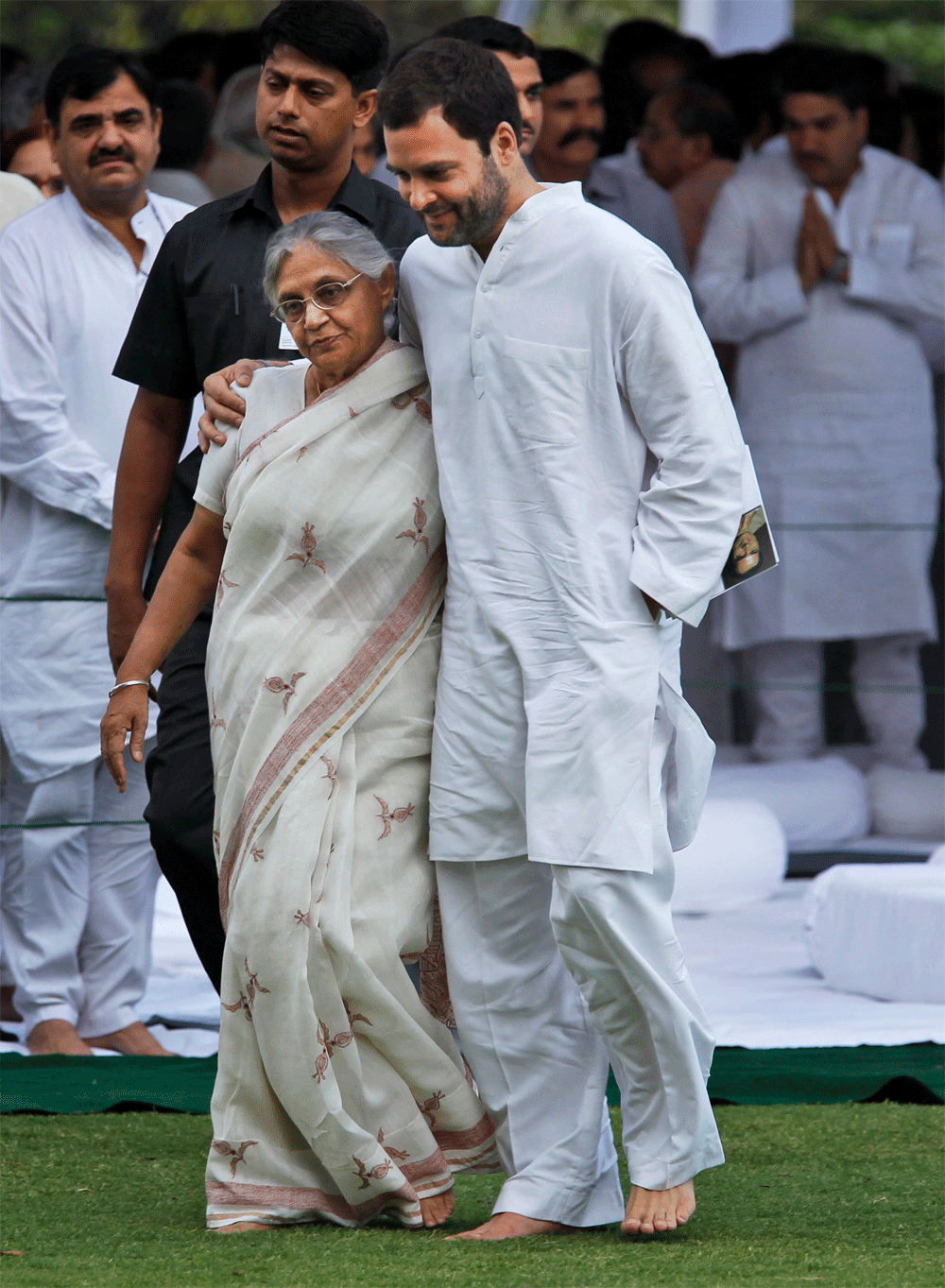 Rahul Gandhi puts his arm around New Delhi Chief Minister Sheila Dikshit as dignitaries gathered at the memorial of former Indian Prime Minister Rajiv Gandhi on occasion of his death anniversary, in New Delhi, India, Monday, May 21, 2012. Rajiv Gandh...