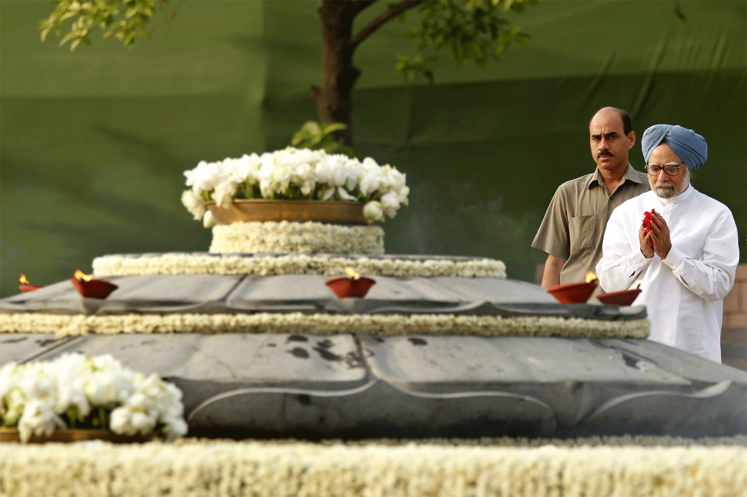 Indian Prime Minister Manmohan Singh pays his respects at Rajiv Gandhi's memorial on occasion of his death anniversary, in New Delhi, India, Monday, May 21, 2012. Rajiv Gandhi was killed in a suicide bomb attack on May 21, 1991 in Tamil Nadu during a...