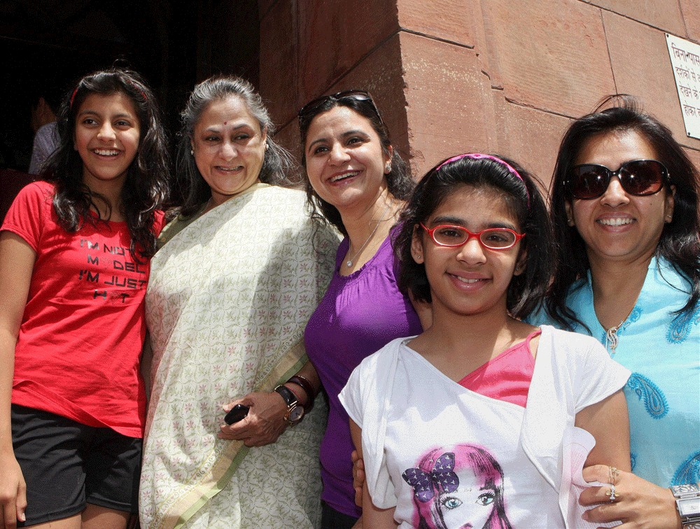 Rajya Sabha member Jaya Bachchan poses for photographs with a group of visitors at Parliament in New Delhi on Monday during the ongoing budget session.