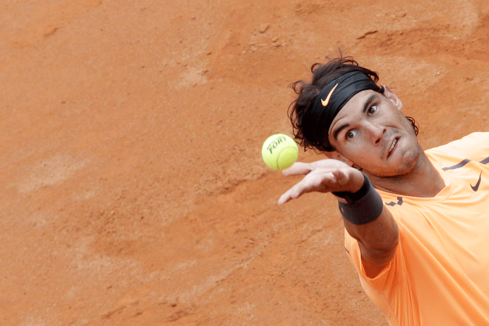 Spain's Rafael Nadal serves the ball to Serbia's Novak Djokovic during their final match at the Italian Open tennis tournament, in Rome, Monday, May 21, 2012.