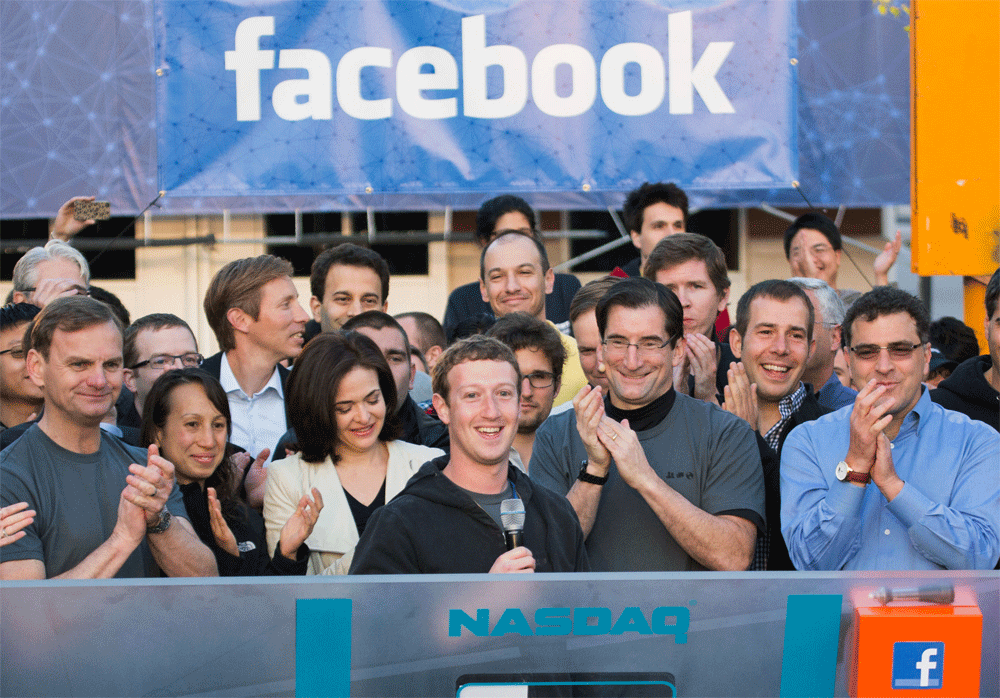 FILE - In this May 18, 2012 file photo provided by Facebook, Facebook founder, Chairman and CEO Mark Zuckerberg, center, rings the Nasdaq opening bell from Facebook headquarters in Menlo Park, Calif. Robert Greifeld, second from right, CEO of the Nas...