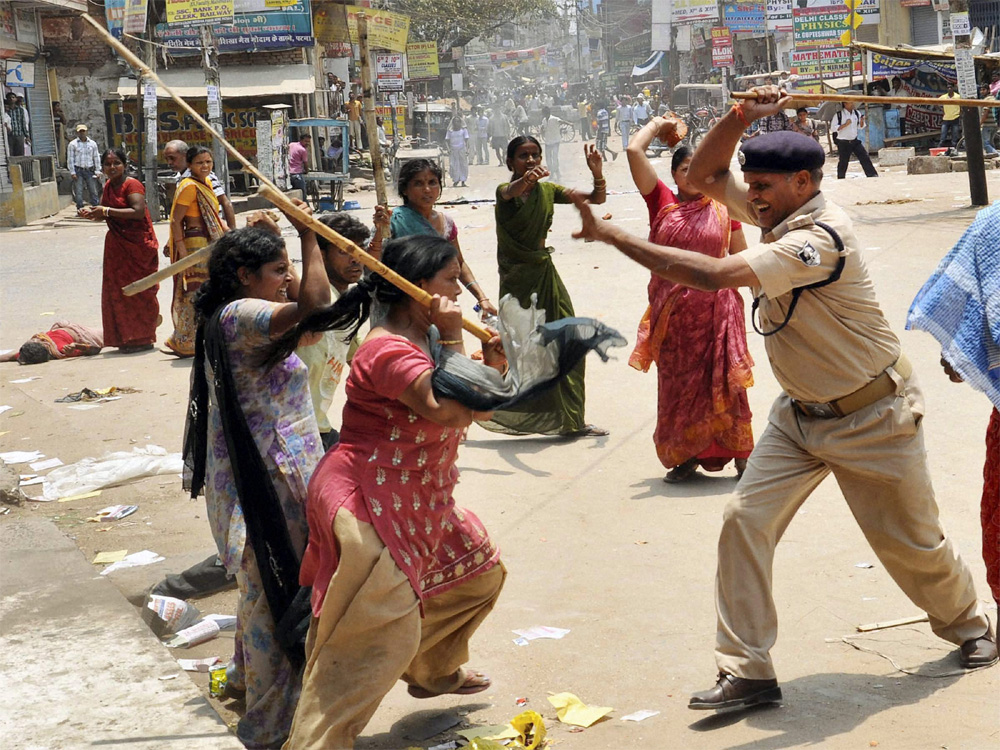 Patna: Police lathi-charge a group of women during a protest over alleged corruption in Municipal Corporation elections in Patna on Monday. PTI Photo