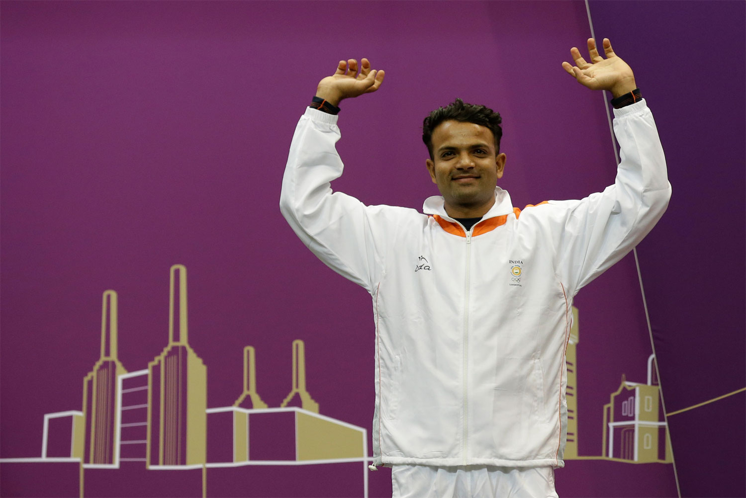 India's Vijay Kumar reacts as he mounts the medals podium to receive a silver for the men's 25-meter rapid fire pistol event at the 2012 Summer Olympics, Friday, Aug. 3, 2012, in London. (AP Photo/Rebecca Blackwell)