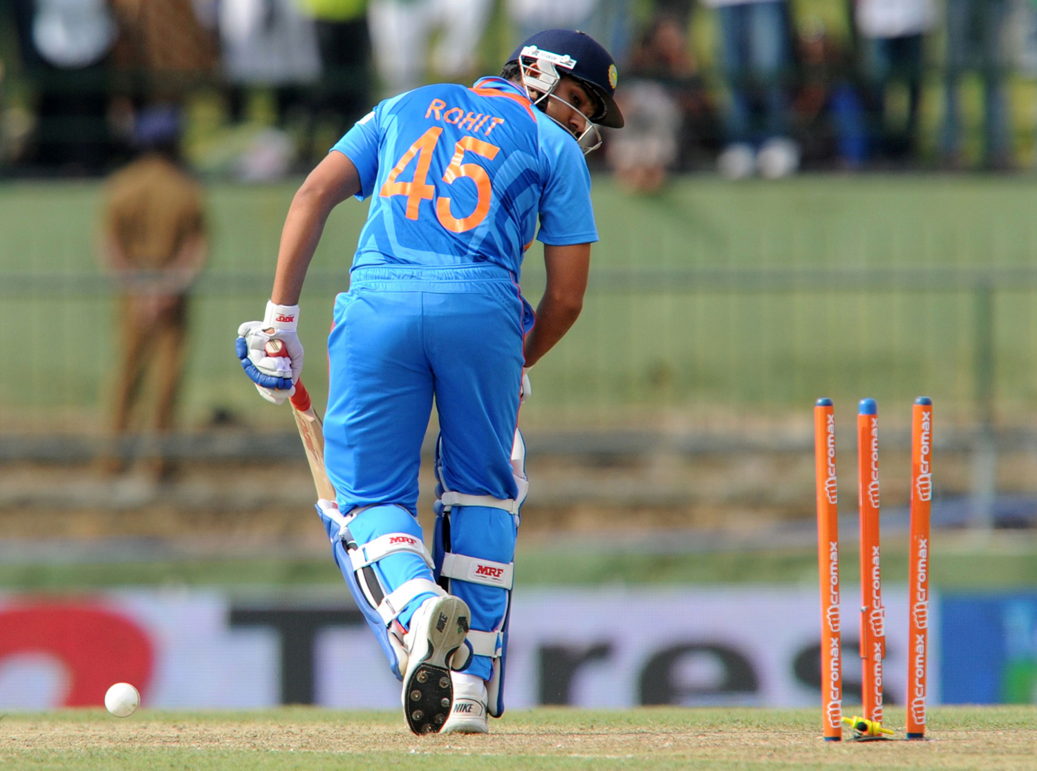 Indian cricketer Rohit Sharma gets dismissed by Sri Lankan cricketer Nuwan Pradeep during the fifth and final one-day international (ODI) match between Sri Lanka and India at the Pallekele International Cricket Stadium in Pallekele on August 4, 2012....