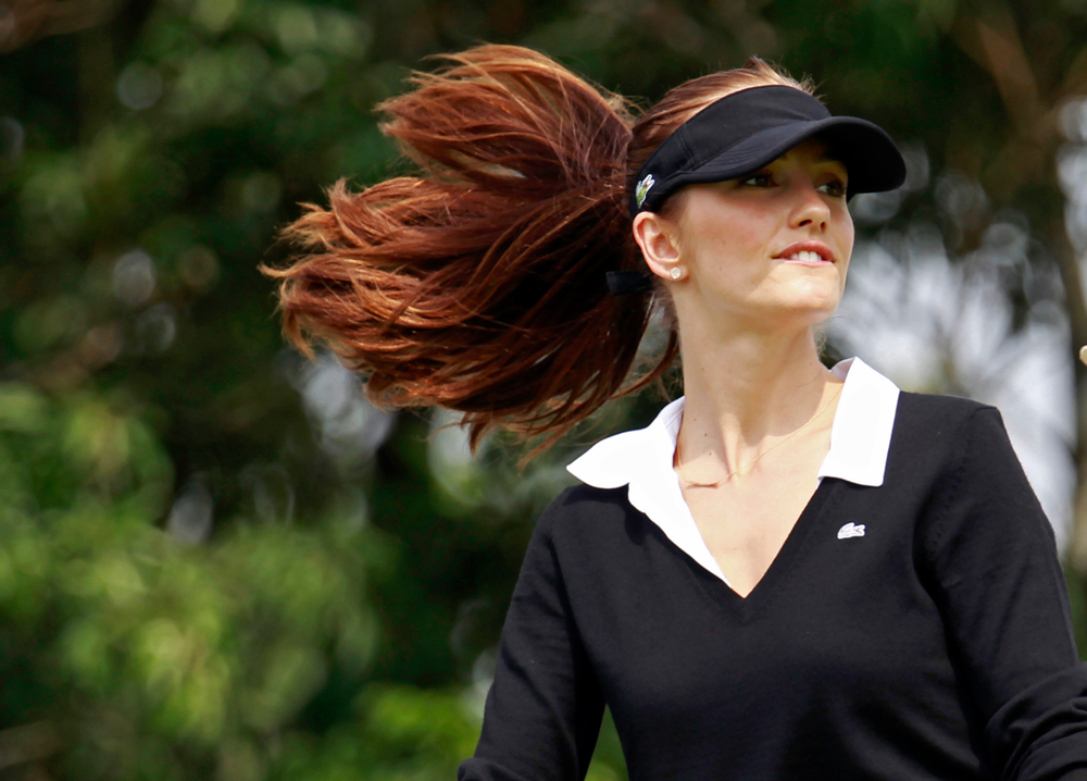 American actress Minka Kelly walks on the fairway during the pro-am games at the World Celebrity Pro-Am golf tournament in Haikou, in southern China's island province Hainan on Friday, Oct. 19, 2012. (AP Photo