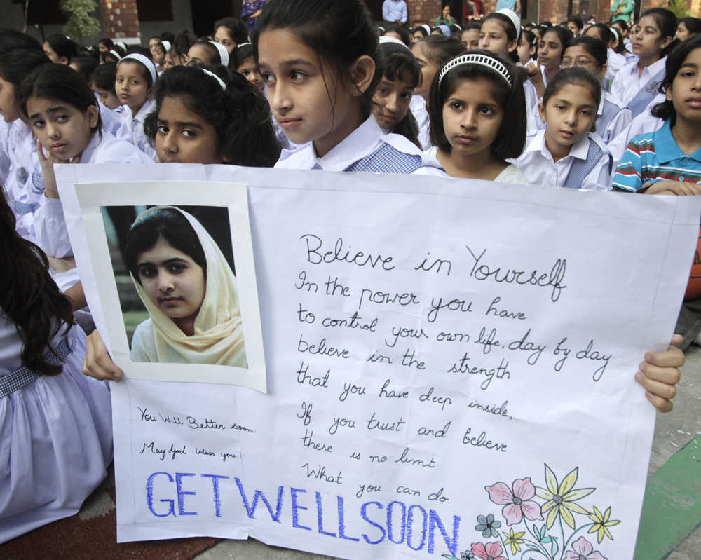 A student holds a placard during special prayers for the recovery of Malala Yousufzai, who was shot by the Taliban, at the Sacred Heart Cathedral School in Lahore October 19, 2012.Yousufzai, 14, was shot by the Taliban on October 9, 2012, for speakin...