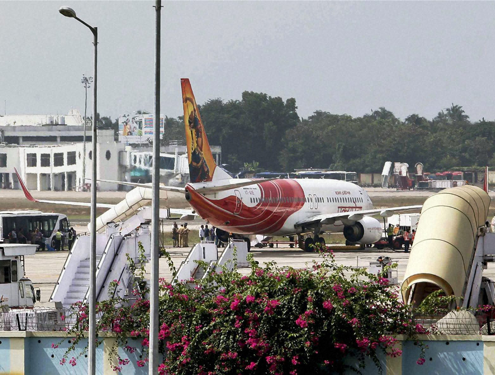 An Abu Dhabi-Kochi Air India flight parked at the airport in Thiruvananthapuram on Friday. High drama unfolded at the airport on Friday when the pilot of the plane pressed the hijack button in panic after passengers created a ruckus in the cockpit fo...