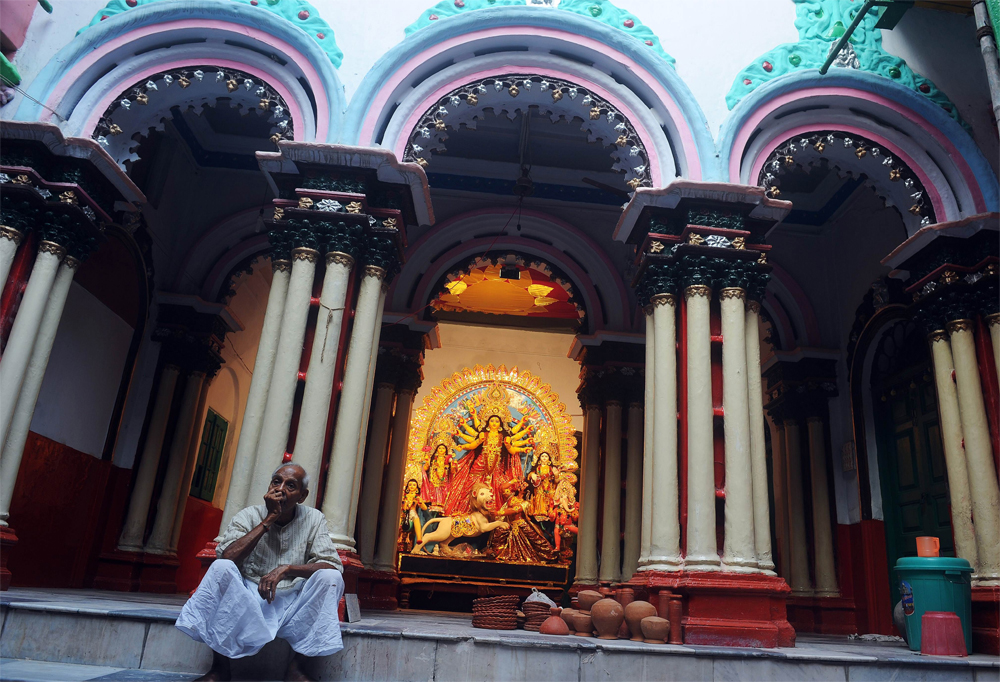 An Indian man waits for a priest infront of an idol of Hindu goddess  Durga displayed for the upcoming Hindu festival Durga Puja in Kolkata on  October 19, 2012. The five-day Durga Puja festival commemorates the  slaying of the demon king Mahishasur ...