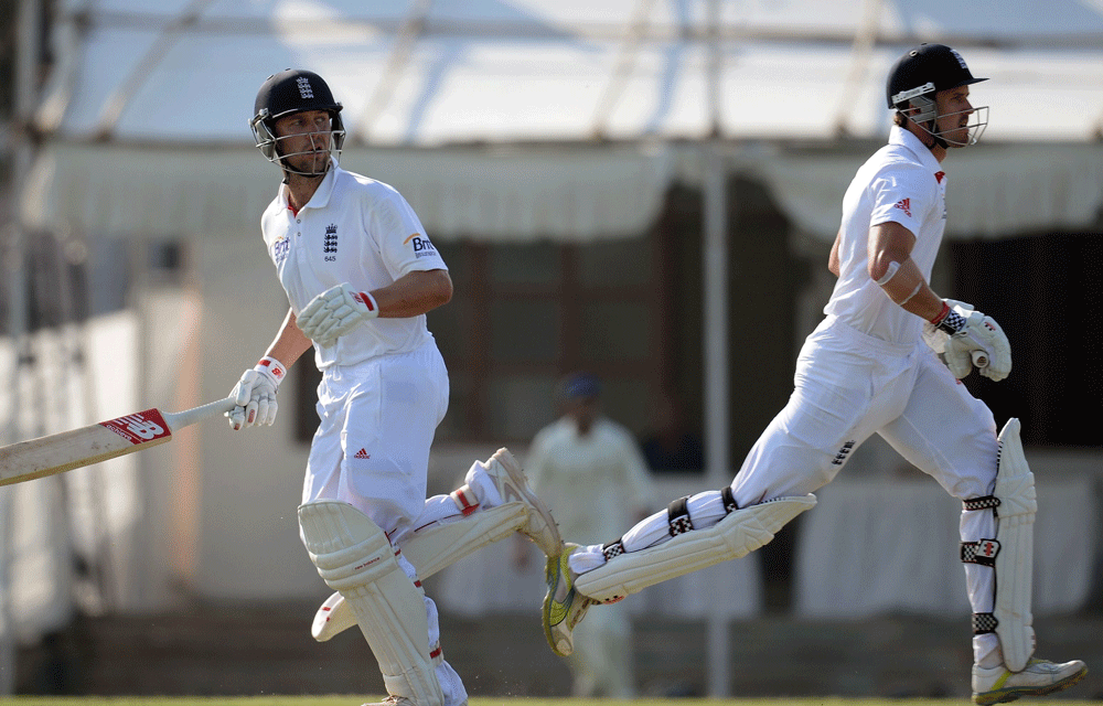 England cricketers Nick Compton (R) and Jonathan Trott run between the wickets during the third day of a four-day practice match between England and Haryana at The Sardar Patel Stadium ground B at Motera in Ahmedabad on November 10, 2012. The England...