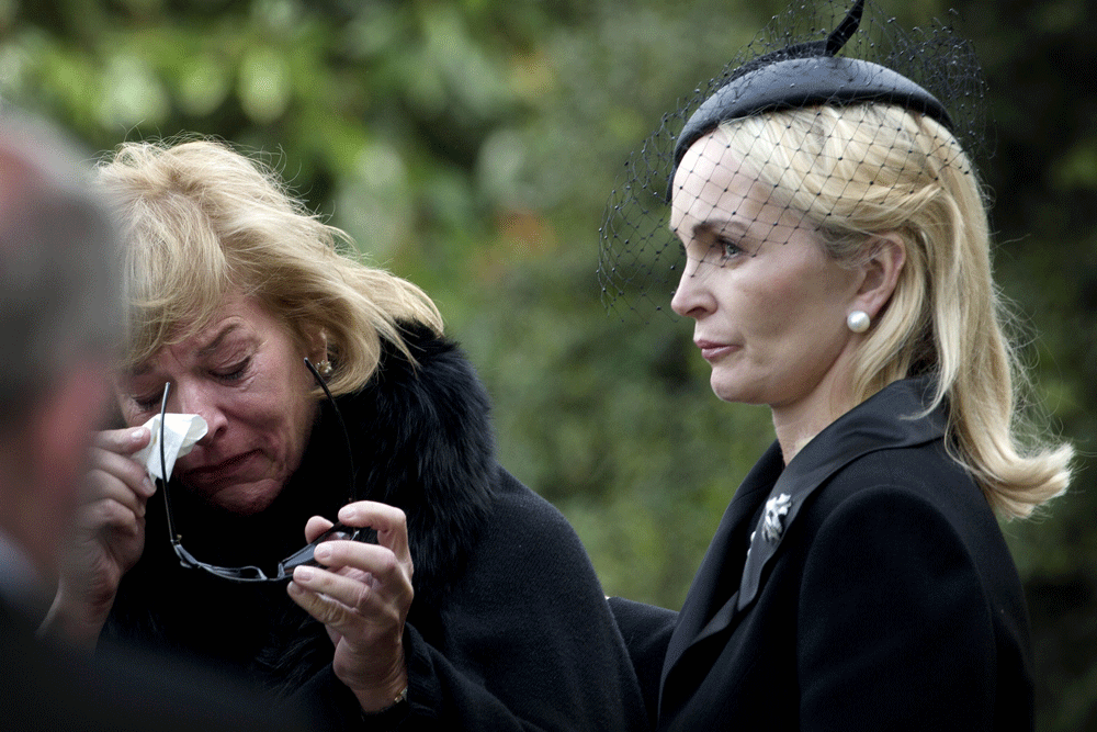 Carol Thatcher (L), daughter of British former prime minister Margaret  Thatcher is consoled by Mark Thatcher's wife Sarah (R) as they arrive at  Mortlake Crematorium, west of London after the ceremonial funeral of  British former prime minister Marg...