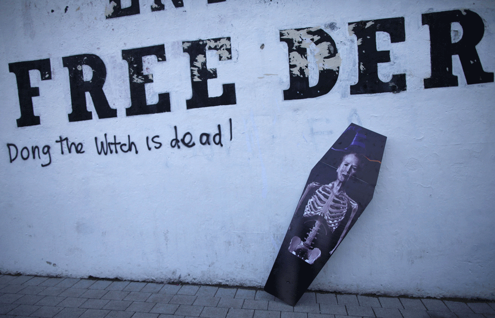 A mock coffin falls over under anti-Thatcher graffiti saying 'Ding Dong  the Witch is dead' before a demonstration against the British former  prime minister Margaret Thatcher in Londonderry, Northern Ireland on  April 17, 2013. The funeral of Margar...