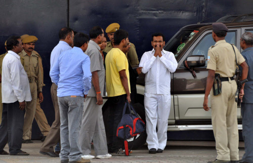 Former Chief Minster of Jharkhand, Madhu Koda (C), gestures outside the Hotwar jail on a three week interim bail in Ranchi on April 18,2013. Koda was granted three-week's provisional bail yesterday by the high court on the ground of treatment of his ...