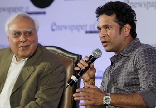Union Minister for Communications & IT, Kapil Sibal looks on as cricketer Sachin Tendulkar speaks during the launch of a digital newspaper 'enewspaper of india' in New Delhi on Thursday. PTI Photo by Vijay Verma