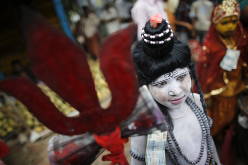 A devotee takes part in the 'Astami Snan' festival by the Brahmaputra river at Langalbandh, 20km (12.5 miles) from the capital Dhaka April 18, 2013. Hindus in Bangladesh are celebrating 'Astami Snan', a festival involving a holy bath ritual in the ri...