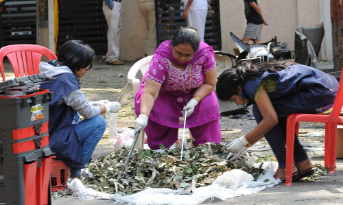 National Investigation Agency (NIA) team sent by the central, collecting the evidences and samples for their investigation at the spot where the bomb blast incident took place near BJP office, in Bangalore on Thursday. -Photo/ VS