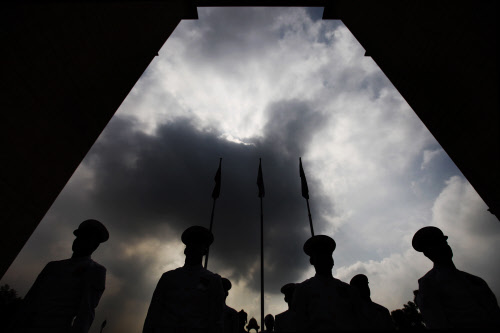 Indian navy personnel are silhouetted as they pay tribute at India Gate  war memorial on the 14th anniversary of India's victory in the Kargil  War in New Delhi, India, Friday, July 26, 2013. Friday marks the second  day of the two-day celebrations o...