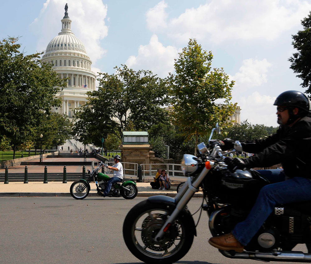 A small group of motorcyclists ride past the U.S. Capitol as part of an effort by riders to make their presence known in the U.S. capital as a counter-protest to a proposed 'Million Muslim March' in Washington, September 11, 2013. REUTERS
