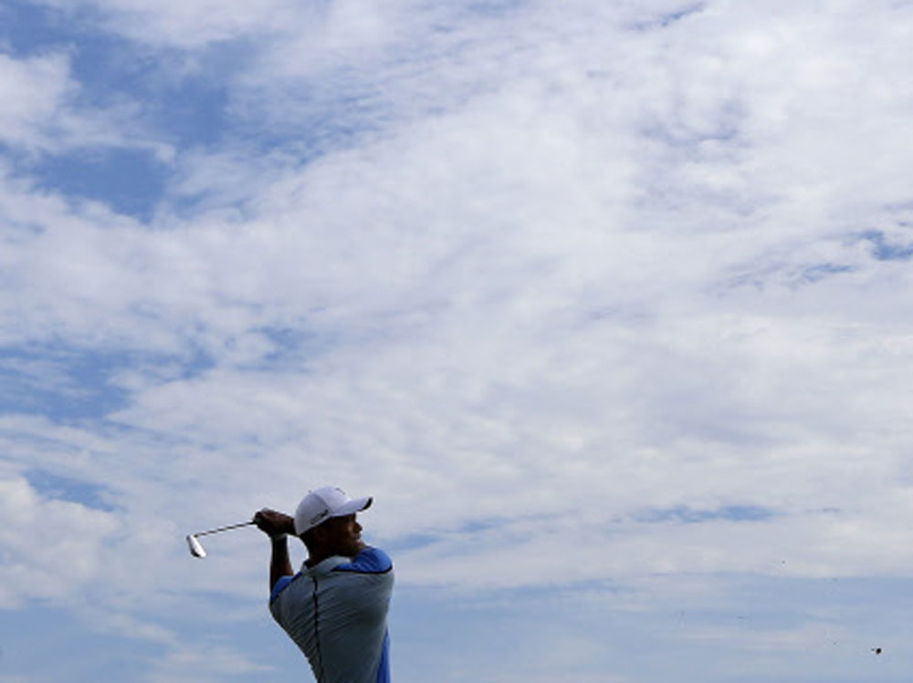 Tiger Woods of the U.S. watches his tee shot on the 17th hole during the Pro-Am round of the BMW Championship golf tournament at the Conway Farms Golf Club in Lake Forest, Illinois September 11, 2013. REUTERS