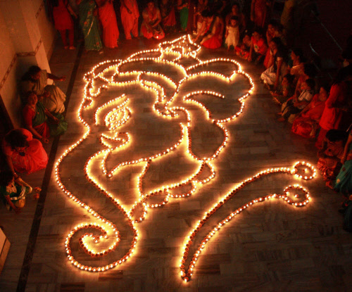 Devotees light 1008 lamps to form Lord Ganesha's image, during Ganesh Utsav celebrations in Gurgaon on Wednesday. PTI Photo