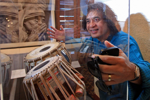 Tabla maestro Ustad Zakir Hussain poses for a photograph with the tablas of his father Ustad Allah Rakha which he donated to an NGO for a charity auction in Mumbai on Monday.PTI Photo