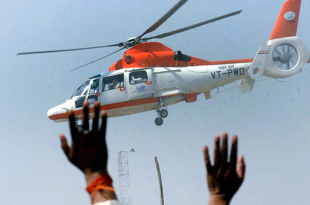 Sasaram : Congress President Sonia Gandhi waves to supporters from a  chopper after an election rally in Sasaram on Thursday. PTI Photo