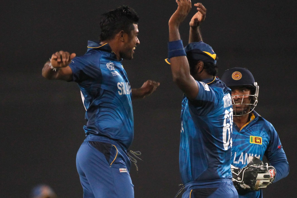 Sri Lanka's Angelo Mathews congratulates bowler Seekkuge Prasanna (L) after he successfully dismissed West Indies' Lendl Simmons during their semi final-match in the ICC Twenty20 World Cup at the Sher-E-Bangla National Cricket Stadium in Dhaka April ...