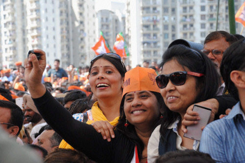 Supporters during BJP Prime Ministerial candidate Narendra Modi's election campaign rally in Ghaziabad on Thursday. PTI Photo