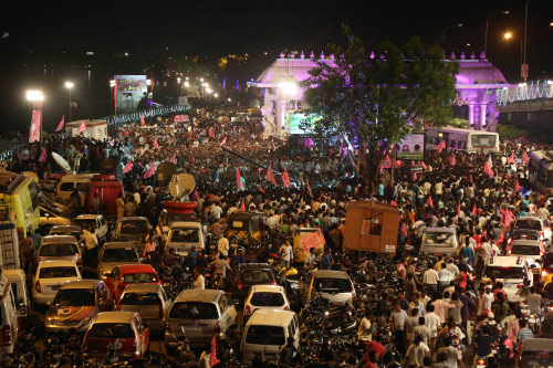People celebrate on the street the formation of India's 29th state, Telangana, in Hyderabad. Celebrations greeted the creation on Monday of India's newest state of Telangana, marking the formal division of the southern state of Andhra Pradesh. (AP Ph...