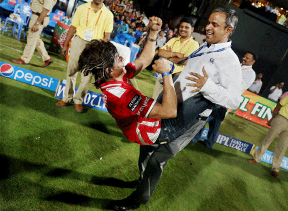 Kolkata Knight Riders owner Shahrukh Khan dances with a team official as they celebrate their win over Kings XI Punjab in the IPL 7 final match at M Chinnaswamy stadium in Bengaluru. PTI Photo 
