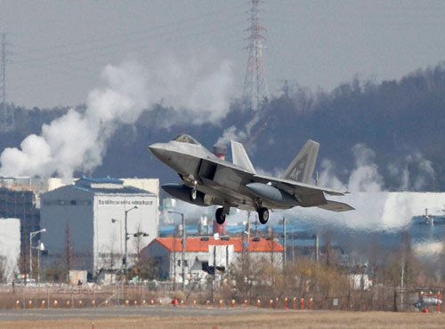 One of four U.S. F-22 stealth fighters prepares to land at Osan Air Base in Pyeongtaek, South Korea, Wednesday, Feb. 17, 2016. Four U.S. F-22 stealth fighters flew over South Korea on Wednesday in a clear show of power against North Korea, a day afte...