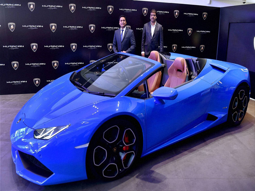 Lamborghini India Head Sharad Agarwal (L) and T S Sateesh(R),Chairman & MD Lamborghini Bengaluru pose with newly launched Huracan LP 610-4 Spuder at a press conference in Bengaluru on Friday. PTI Photo.
