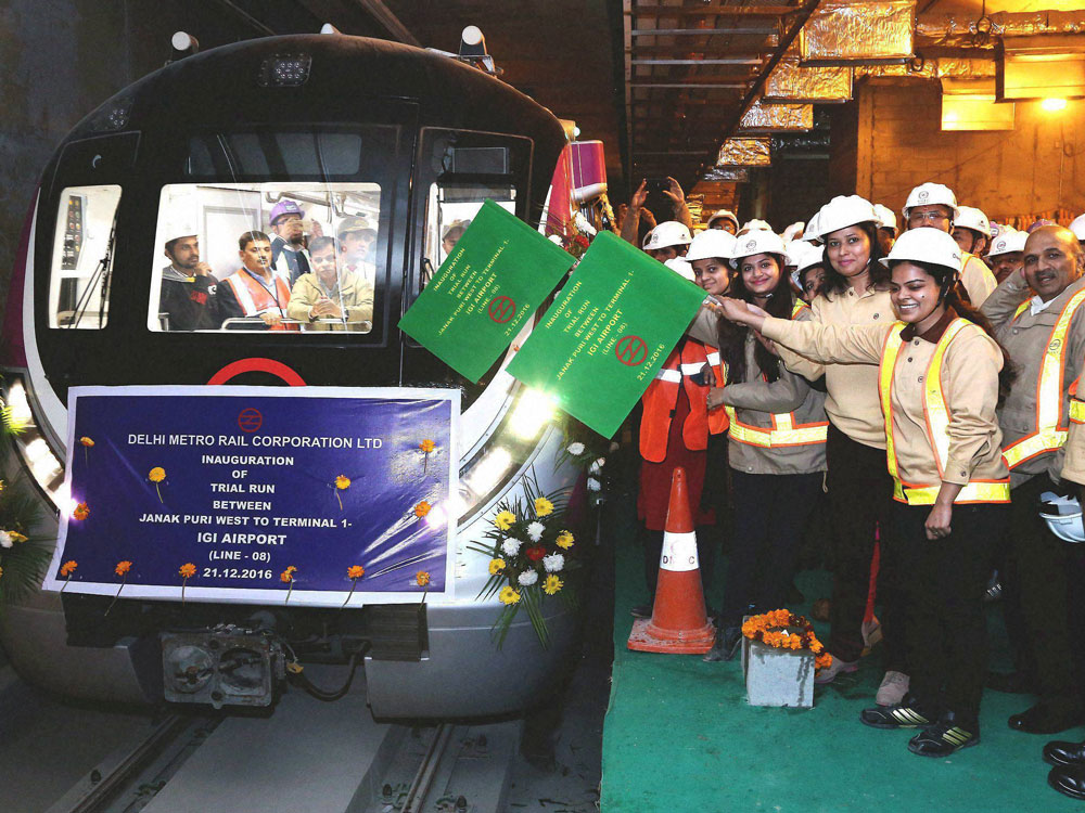 DMRC's lady engineers and officers flagging off the trial Metro train from Janakpuri West to Terminal 1 - IGI Airport in New Delhi on Wednesday. PTI Photo