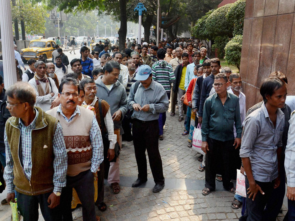 People wait in serpentine queues to deposit and exchange old 500 and 1000 notes at the Reserve Bank of India in Kolkata on Wednesday. PTI Photo