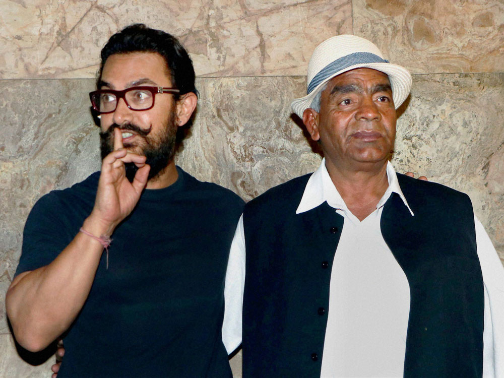 Bollywood actor Aamir Khan with wrestler Mahavir Singh Phogat at the special screening of film Dangal in Mumbai, on Tuesday. PTI Photo