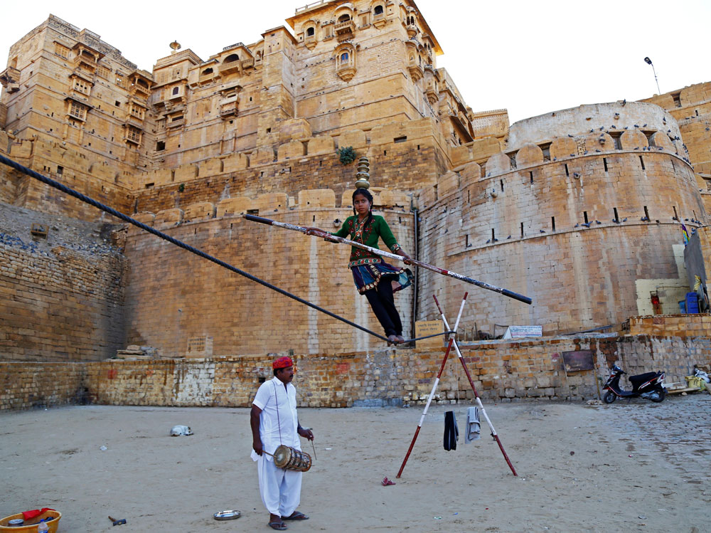 A tightrope walker performs on a rope while holding a balancing pole at the Jaisalmer Desert Festival in Jaisalmer, in the desert state of Rajasthan, India February 9, 2017. REUTERS