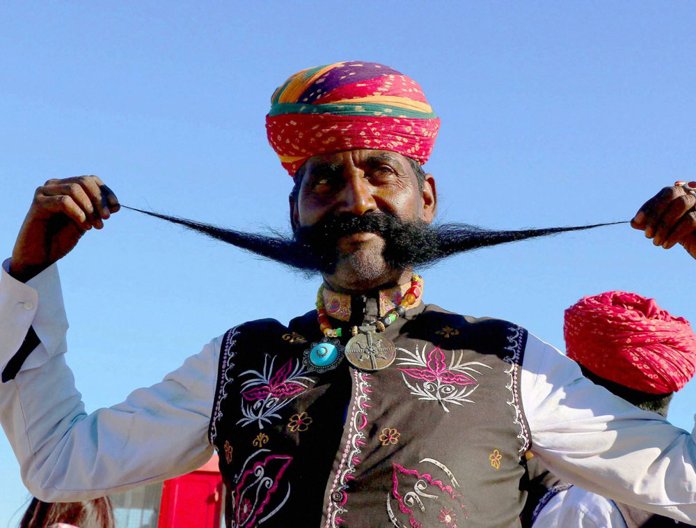 A Rajasthani man twirls his long moustache at the 'Desert Festival 2017' in Rajasthan's Jaisalmer on Thursday. PTI Photo