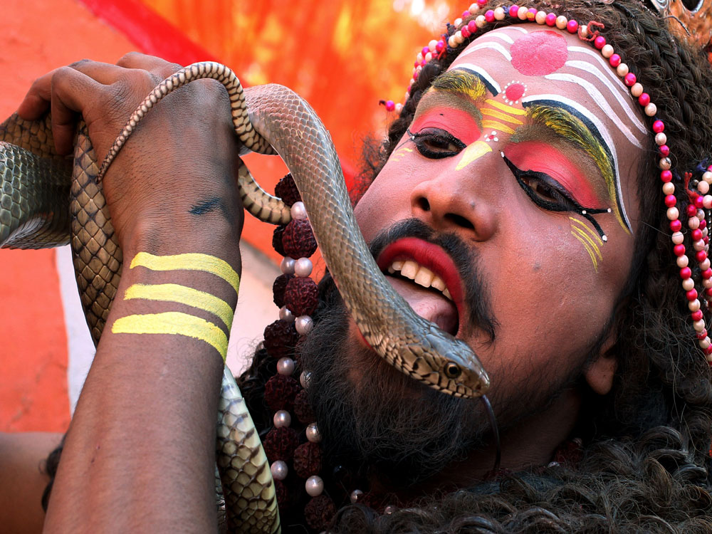 A man dressed as Hindu Lord Shiva performs during a religious procession ahead of the Hindu festival of Maha Shivaratri, in Jammu. Reuters Photo.