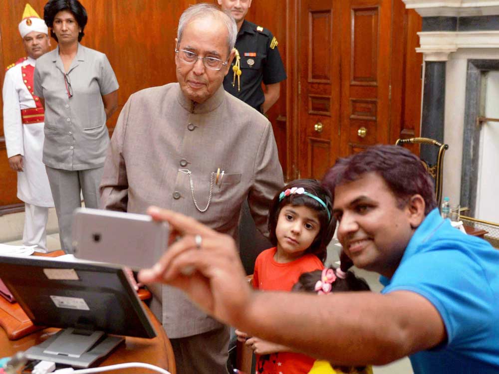 President Pranab Mukherjee launching the Mobile App 'Selfie with Daughters' at Rashtrapati Bhavan in New Delhi on Friday.
