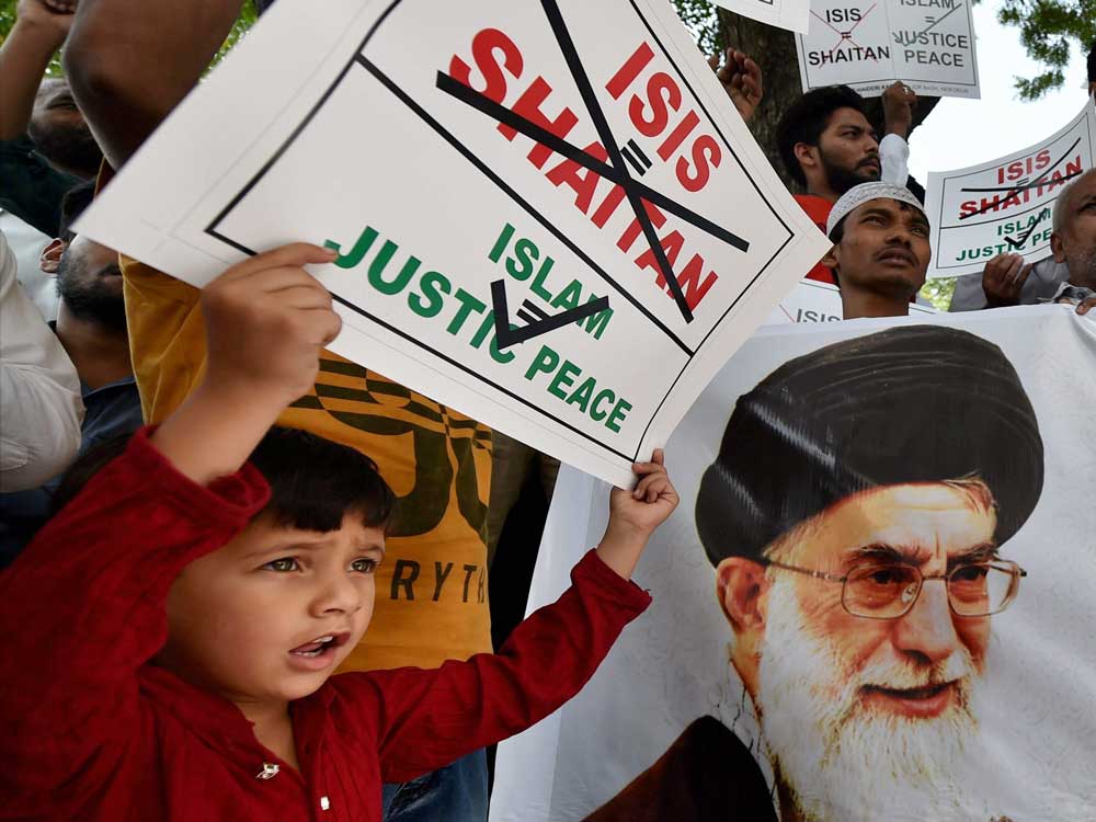A child displays a placard as Muslims protest in New Delhi on Friday against the recent terrorist attacks in Tehran.