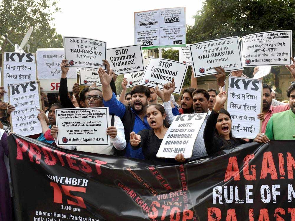  NGO activists and students display placards and shout slogans against cow-vigilantes (Gau Rakshak) during a protest demanding justice for the mob lynching victim Ummar Khan of Rajasthan, at Bikaner House in New Delhi on Wednesday. 