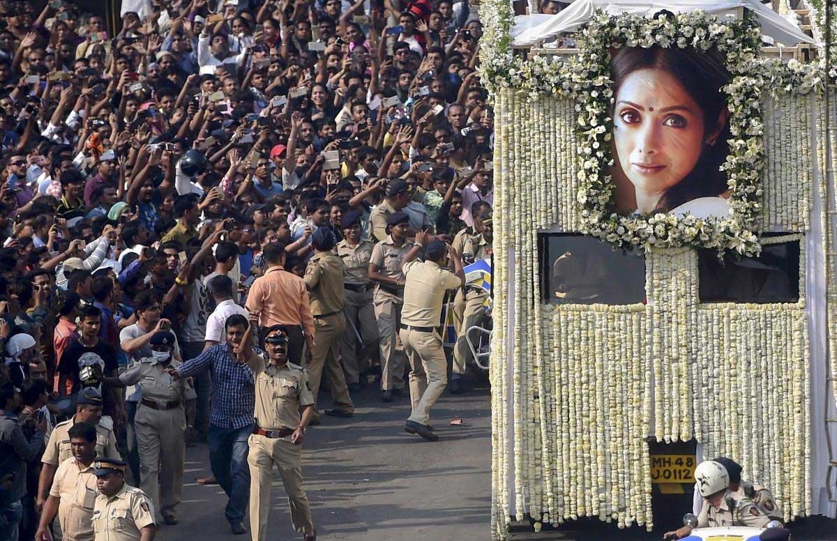 People gather in large number to pay their respect during the funeral procession of actor Sridevi in Mumbai on Wednesday. PTI Photo