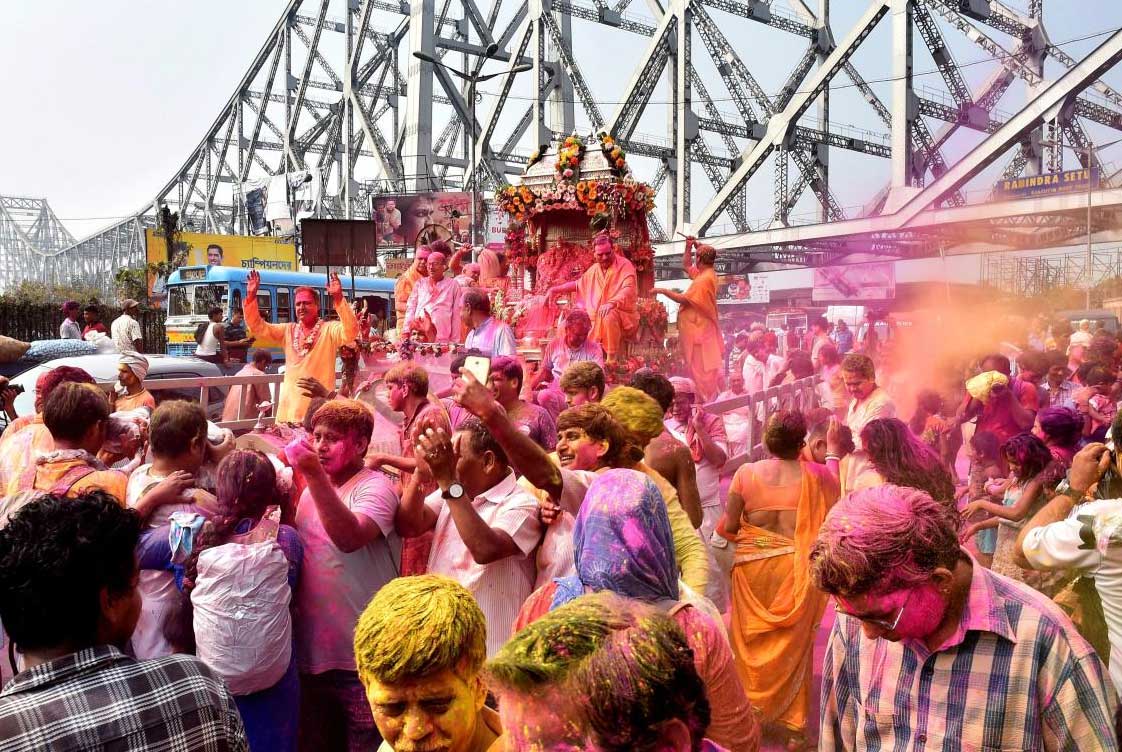  People celebrate Holi during a religious procession on the Howrah bridge in Kolkata on Wednesday. PTI Photo 