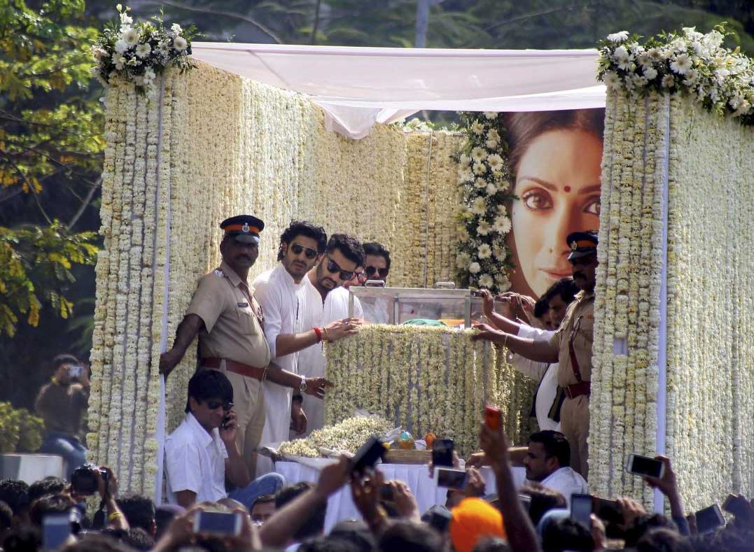 Actors Anil Kapoor and Arjun Kapoor on a funeral truck as a large number of people gather to pay respect during the funeral procession of actor Sridevi in Mumbai on Wednesday. PTI Photo 