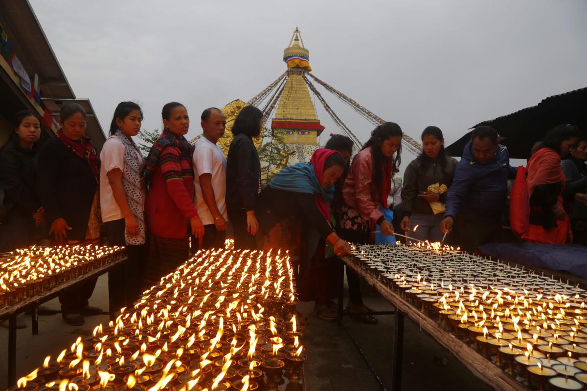 Nepalese Buddhist devotees line up in a queue to light butter lamps in a monastery during Buddha Jayanti or Buddha Purnima in Boudhanath stupa, Kathmandu, Nepal. AP/PTI Photo